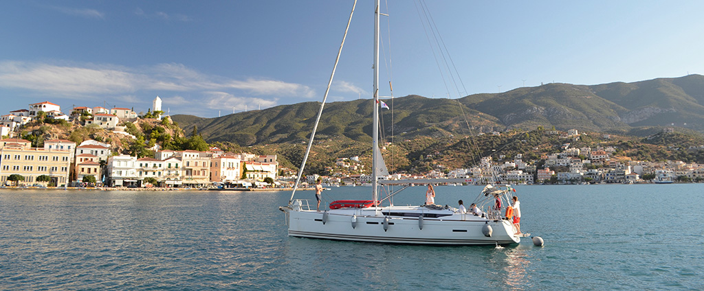 Sailing adventure in Greece with The Big Sail – Yacht gliding on the crystal-clear waters of the Mediterranean, with a backdrop of Greece's iconic coastline and rugged landscapes.