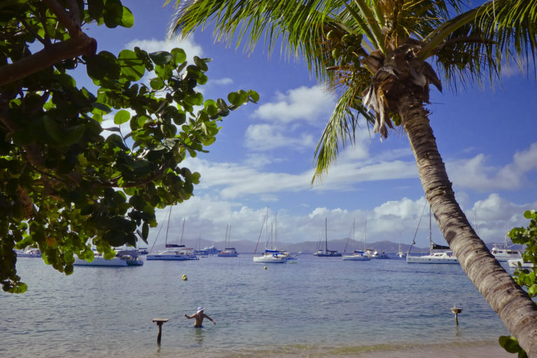 Caribbean BVI Yacht Charter at Cooper Island with The Big Sail – Luxury sailing yacht anchored near the scenic shores of Cooper Island in the British Virgin Islands, surrounded by clear turquoise waters and tropical landscapes.
